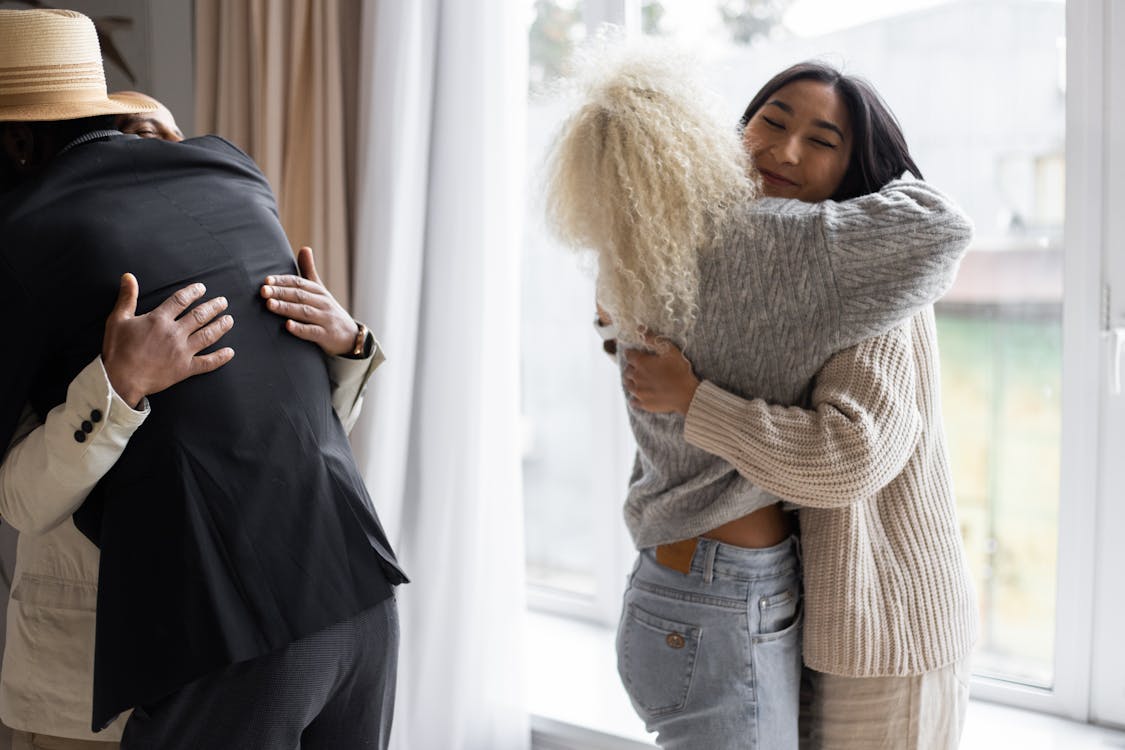 Friends sharing a warm embrace, representing social health and human connection