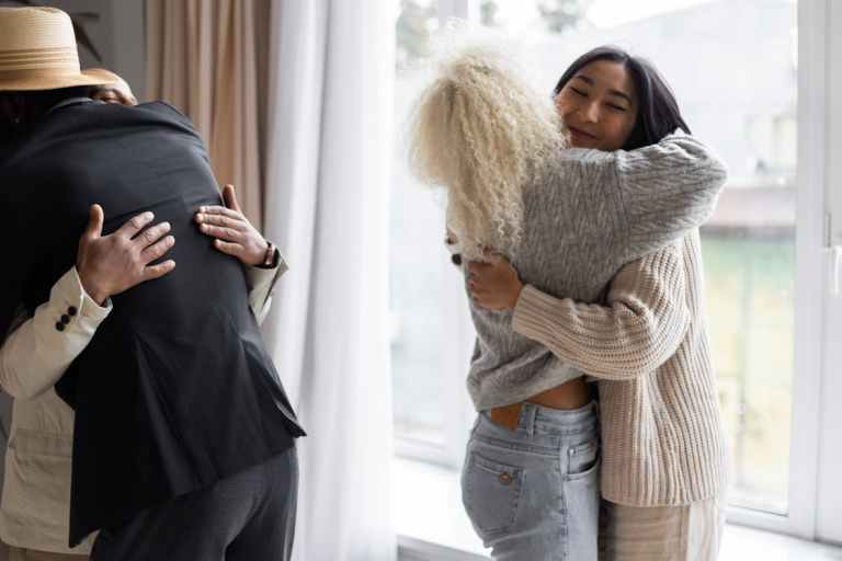 Friends sharing a warm embrace, representing social health and human connection